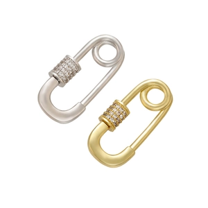 Macro detail of gold and silver safety pin pendants with micro-pave zircon crystals