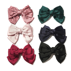 Large satin bow hair clips in multiple colors including burgundy and emerald green