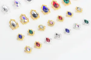 Close-up of teardrop and marquise nail rhinestones with gold and silver alloy frames