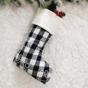 Detail of 18 inch plaid Christmas stocking with white paw print and pine berry decor