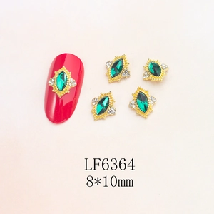 Macro detail of 8x10mm green marquise nail gems with gold retro frames and micro-diamonds