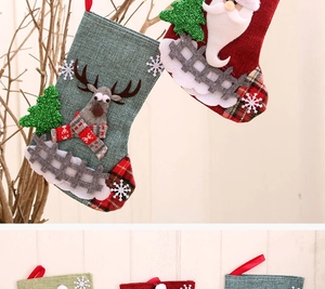 Detail of 3D reindeer and Santa Claus linen Christmas stockings with red plaid trim