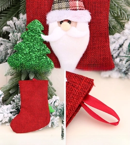 Detail of linen Christmas stocking with Santa Claus applique and red ribbon hanging loop