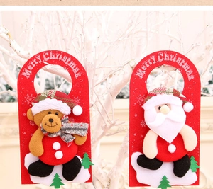 Detail of felt Merry Christmas door hangers featuring Santa and bear on white branches