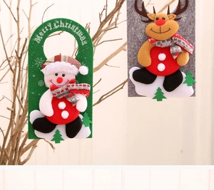 Detail of felt Christmas door hangers with snowman and reindeer on natural branches