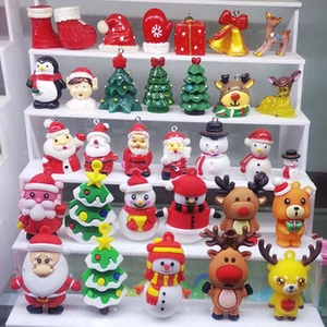 Collection of Christmas resin charms including Santa, snowmen, and reindeer on display
