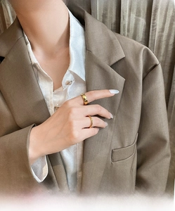 Detail of minimalist 18K gold plated titanium steel stackable rings on a model finger