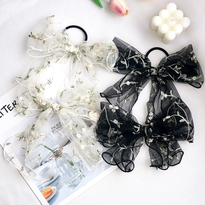 Elegant Korean style large mesh bow hair clips with delicate floral embroidery on fabric