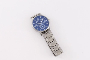 Detailed close-up of McyKcy silver quartz watch with deep blue dial and triple sub-dials