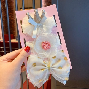 Detailed set of baby headbands featuring gold crowns and lace flowers on pink card