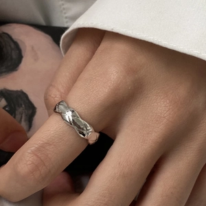 Elegant silver open ring with geometric diamond pattern texture on model finger