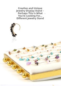 Detailed view of jewelry display tray with white velvet inlay and golden metal frame