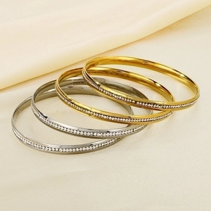 Detail of 5.5mm stacked bangles featuring polished finish and sparkling crystal pavé