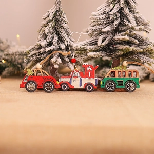 Three assorted wooden Christmas car ornaments with JOY prints on a snowy background
