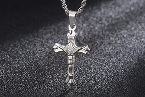 Detailed macro view of silver stainless steel crucifix pendant with INRI engraving