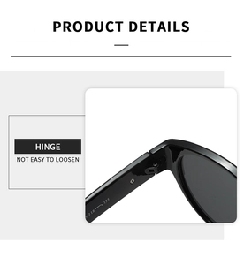 Détail de la charnière en métal sur des lunettes de soleil ovales noires avec taille