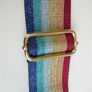 Detailed close-up of rainbow striped metallic glitter strap with gold metal buckle