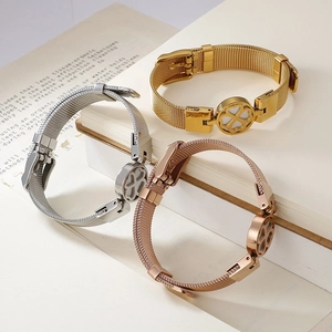 Three-color mesh band bracelets in gold, silver, and rose gold with clover charms