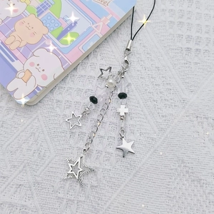 Silver Y2K star and cross phone strap with black beads on a white lace background