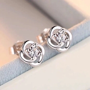 Elegant silver clover flower stud earrings with a sparkling round-cut zircon center