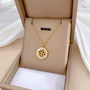 Elegant gold titanium steel necklace with a white shell clover pendant in a gift box