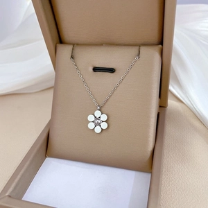 Silver six-petal flower pendant necklace in a beige jewelry box for minimalist women