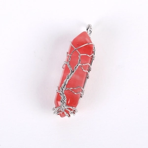 Close-up of red hexagonal stone pendant wrapped in silver wire tree of life design