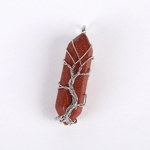 Macro shot of goldstone hexagonal pillar necklace with silver wire-wrapped tree of life