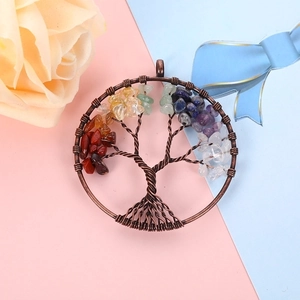 Detail of tree of life pendant with colorful chakra crystal stones in bronze wire wrap