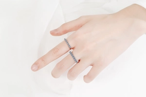 Close-up of S925 sterling silver ring with double T design and moissanite pave stones