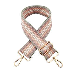 Detail of 5cm wide bohemian geometric woven bag strap with light gold metal clips