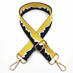 Detail of adjustable jacquard bag strap with mountain pattern and gold lobster clasps