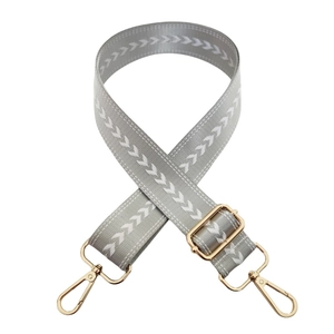 Adjustable grey nylon bag strap with white arrow embroidery and golden metal hardware