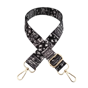 Bohemian black and white geometric wide shoulder strap with gold metal buckles on white background
