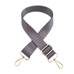Ethnic style woven shoulder strap with geometric patterns and gold metal clasps