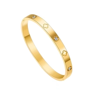 Elegant gold clover bangle with inlaid cubic zirconia on a clean white background