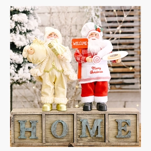 Detailed close-up of standing Santa Claus dolls in gold and red Christmas costumes