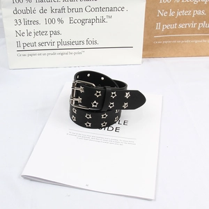 Detail of a punk black belt with silver star studs on a stylish magazine background