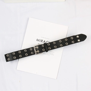 Close-up of black punk belt with double-row star eyelets and silver twin-prong buckle