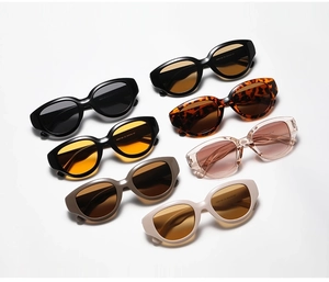 Flat lay detail showing a collection of retro oval cat-eye sunglasses in various colors