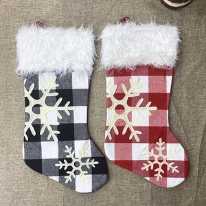 Set of two buffalo plaid Christmas stockings with white faux fur trim and snowflake patterns