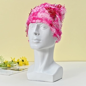 Pink feathered knit beanie for winter featuring warm tassel details and textured yarn