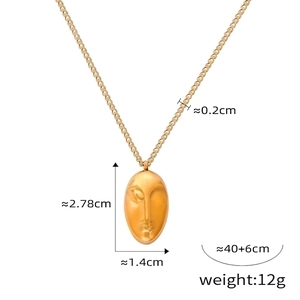 Detail showing dimensions of gold vintage necklace with abstract face cameo pendant