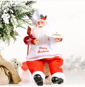 Detailed chef Santa Claus figurine holding cookies with red Merry Christmas apron