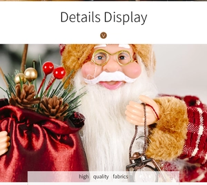 Close-up of Santa doll with white beard, gold glasses, and festive red gift bag