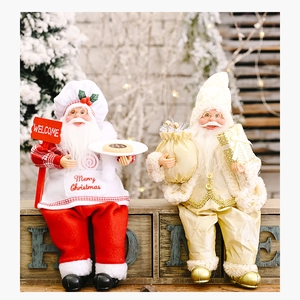 Detail of chef and champagne gold Santa Claus figurines with Merry Christmas embroidery