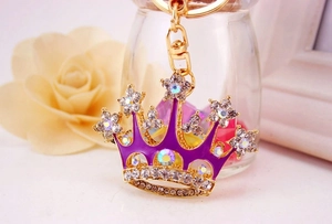 Macro shot of crown keychain with purple enamel finish and sparkling crystal rhinestones
