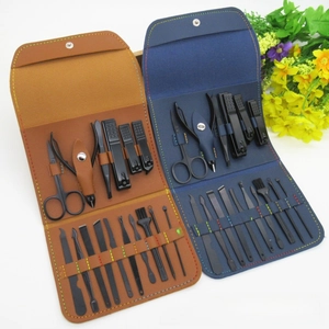 Detailed view of a 16-piece black matte manicure set with brown and blue folding pouches