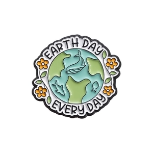 Enamel Earth Day pin with Earth Day Every Day text and floral details on white background