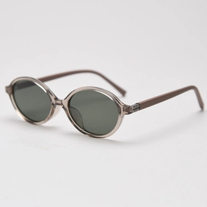 Close-up of retro oval sunglasses with transparent grey frame and dark lenses